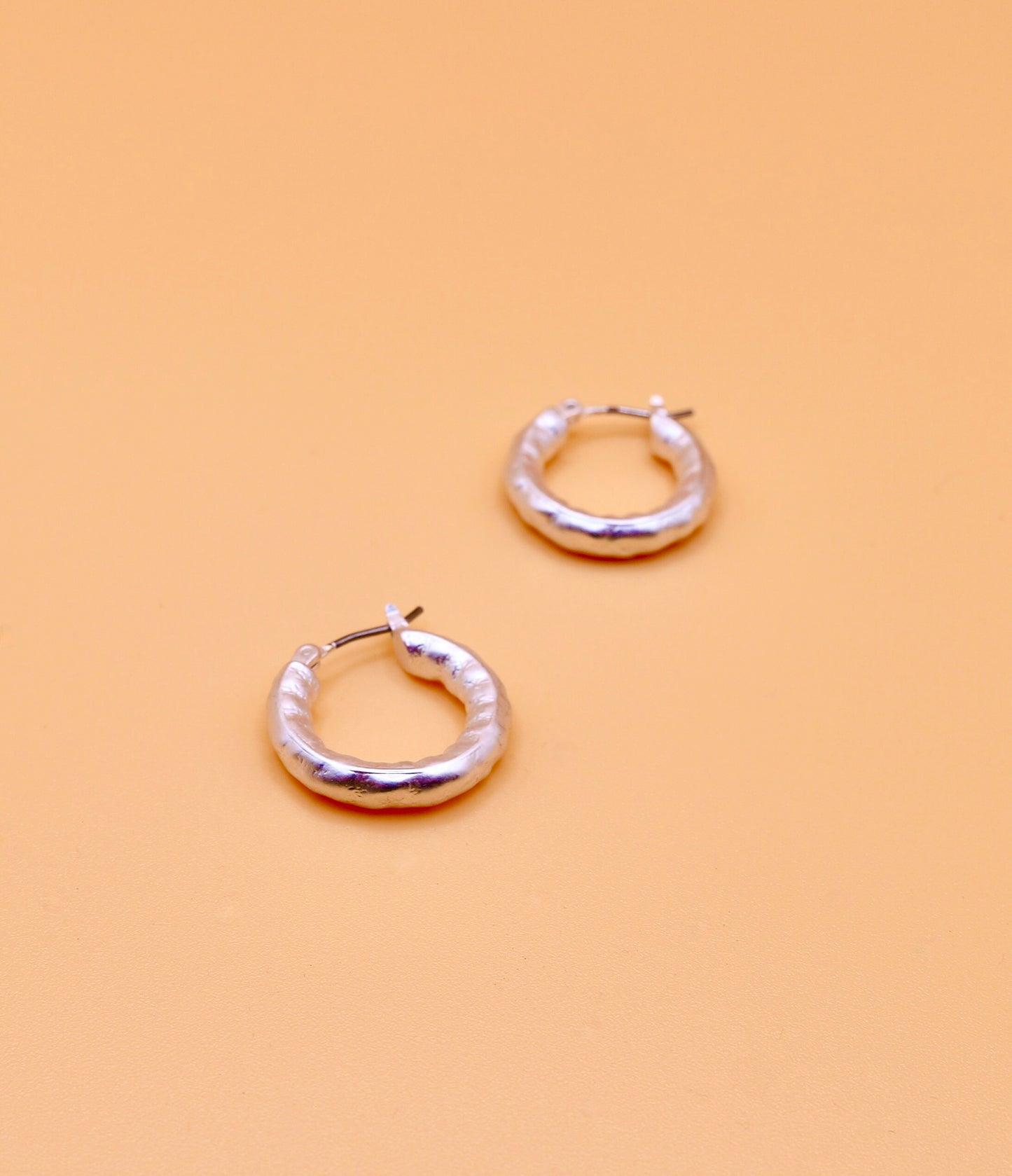 Beaten hoop earrings in silver