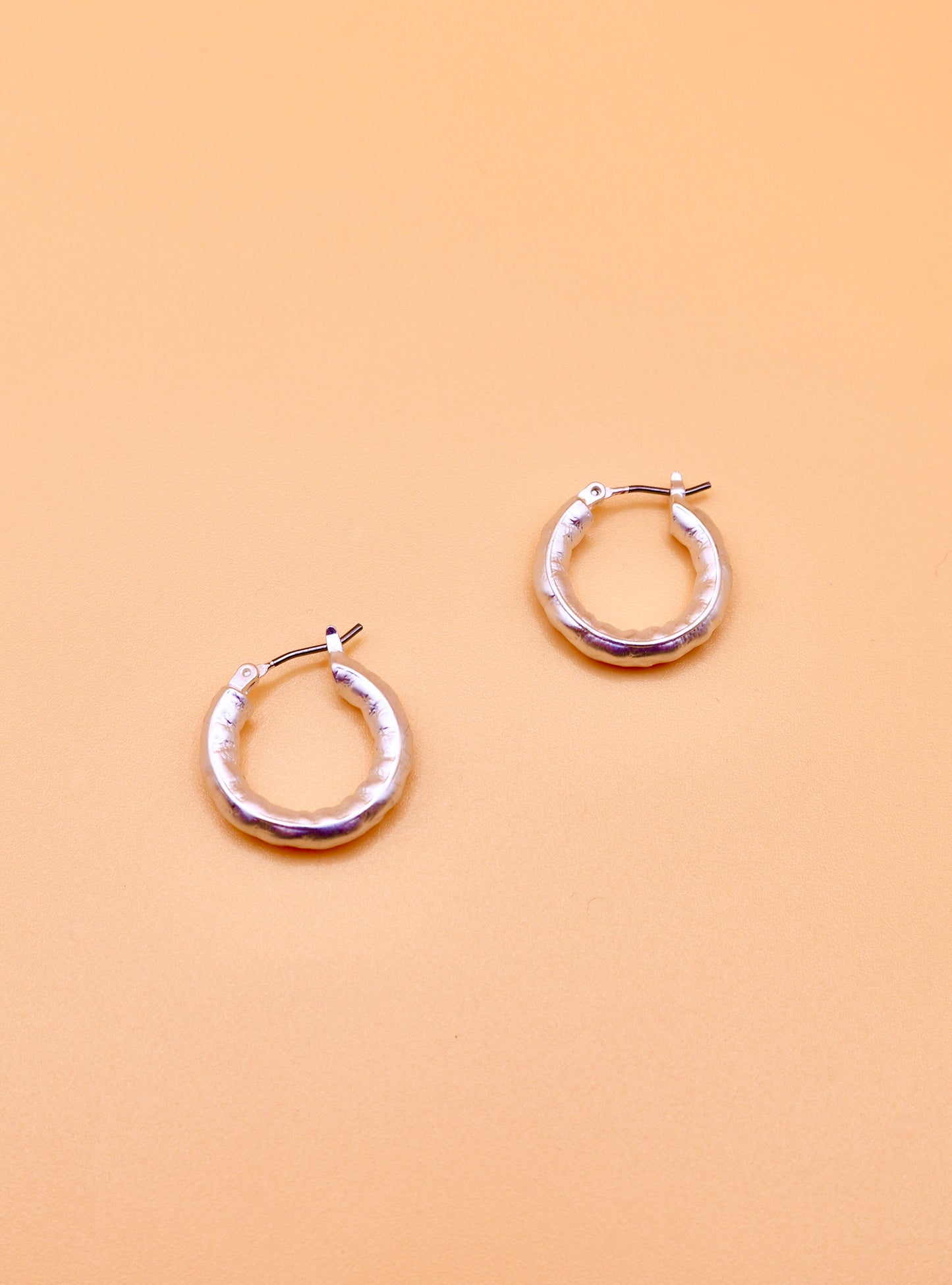 Beaten hoop earrings in silver