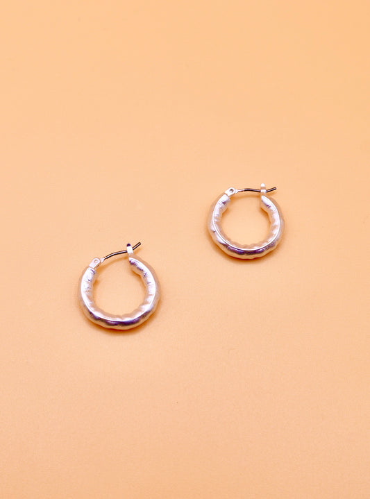 Beaten hoop earrings in silver