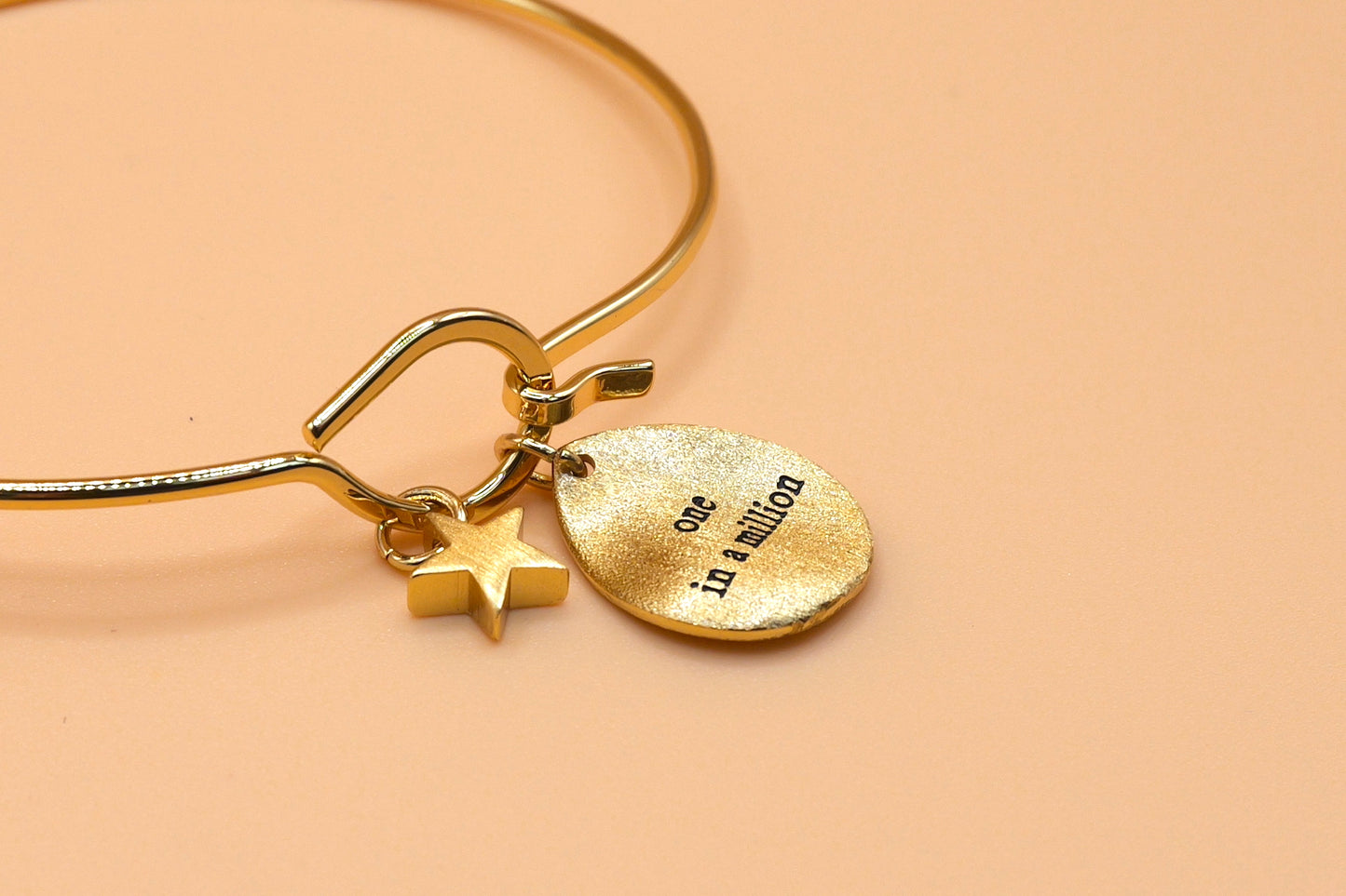 "One in a million" gold charm bangle