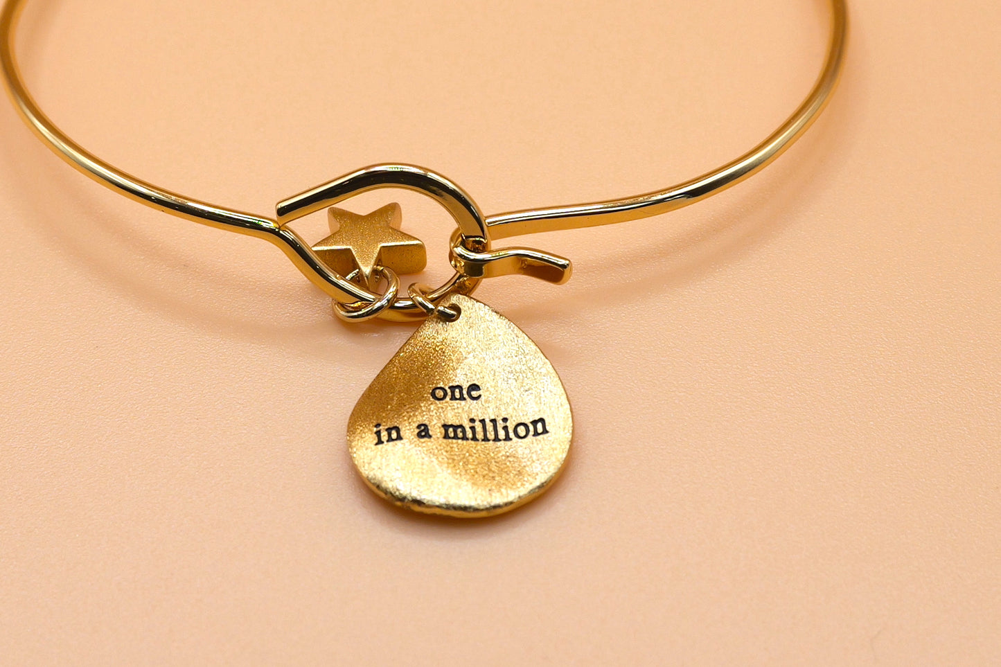 "One in a million" gold charm bangle