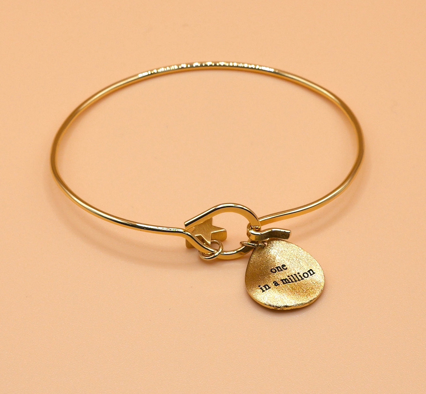 "One in a million" gold charm bangle