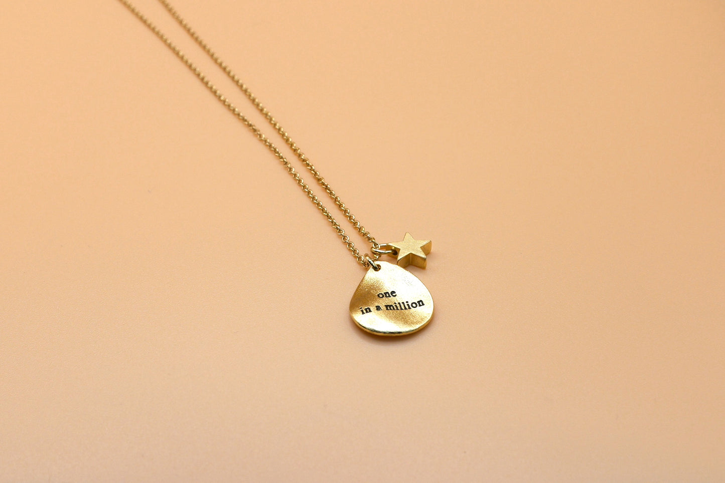 "One in a million" gold charm necklace