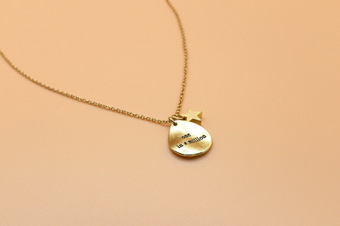 "One in a million" gold charm necklace