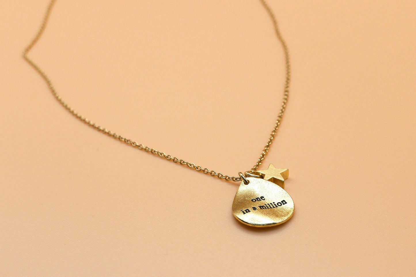 "One in a million" gold charm necklace